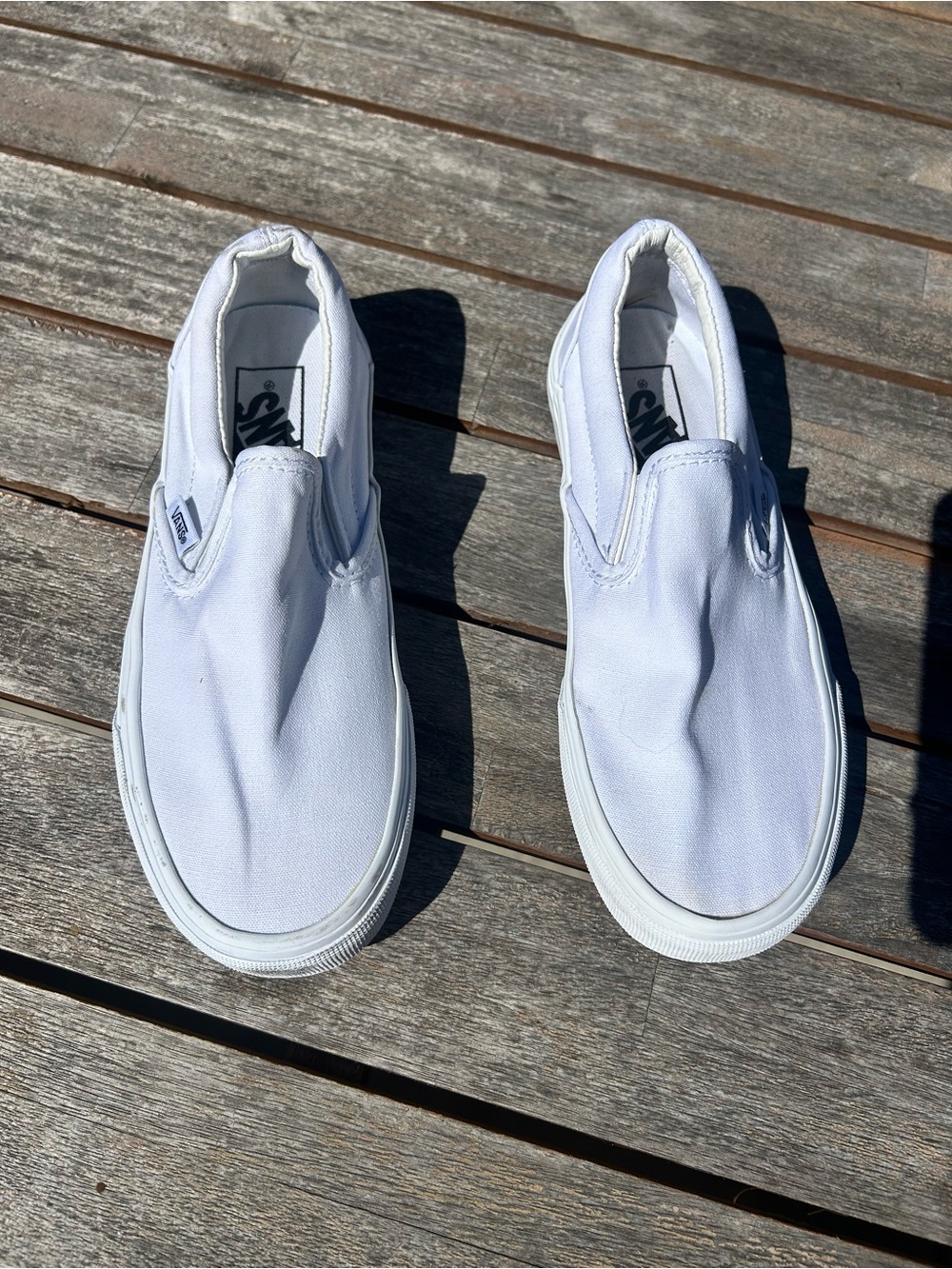 Vans kid’s, men’s, women’s Classic Slip-On in White Canvas. Size women’s 6
